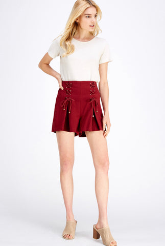 High-waist pleated shorts featuring lace-up